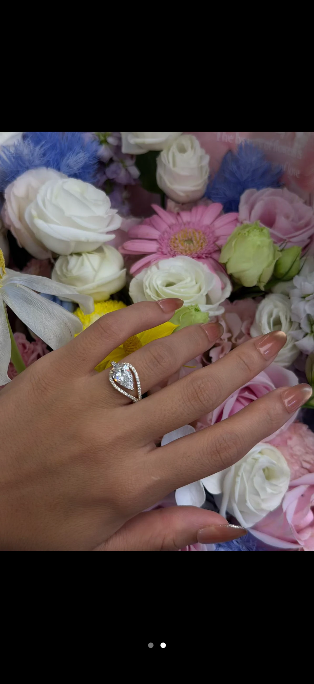 A pear silhouette ring, worn